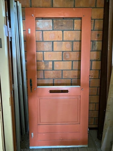 Gebruikte buitendeur 930x2100 rechtsdraaiend stomp hout rood